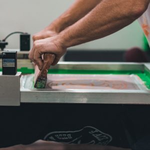 Man screen printing using quality screen and inks